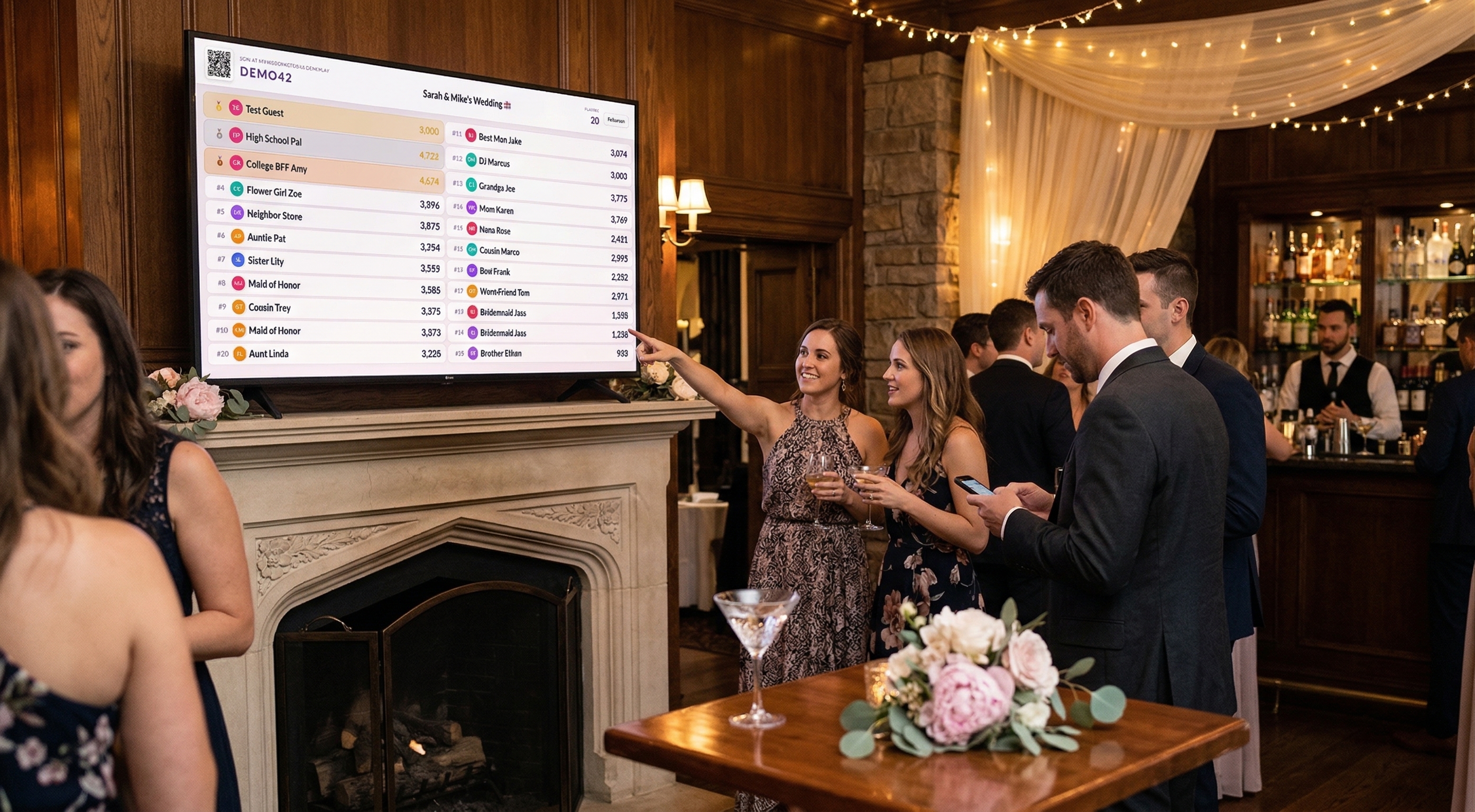 Wedding guests crowded around a TV showing the My Wedding Trivia leaderboard at a wedding reception venue